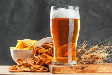 Wall Mural - Beer glass with bretzel and dried sausages snacks close up