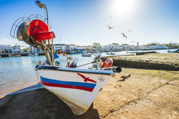 Fisherman boat on bank of Gilao river inTavira, Portugal