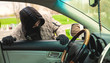 © SZ Photos - Hooded thief looking to break into a car.