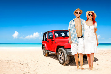 Red summer car on beach and two lovers 