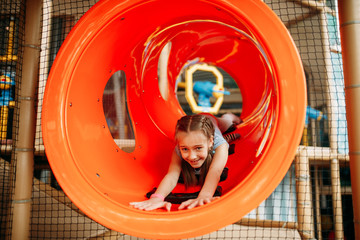 Wall Mural - Girl climbing the maze in children game center