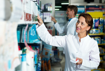 Wall Mural - Female pharmacist in a white coat