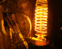 Cobbled Classic Incandescent Edison Light Bulbs With Visible Glowing Wires In The Night