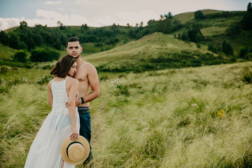 lifestyle . Man and a woman together outdoor. Kiss on the nature.