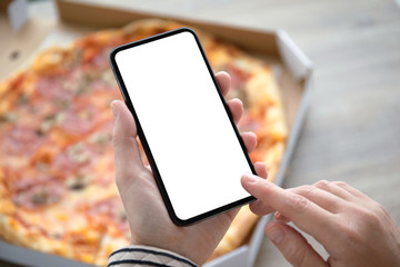 female hands holding phone with isolated screen above pizza box