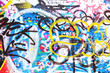 Closeup of texture damaged colorful graffiti wall