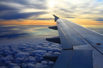 Sunrise from the airplane, high above clouds