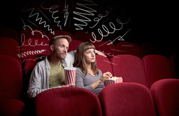 Wall Mural - Young cute couple sitting in cinema, and eating popcorn while watching movie with doodle graphics