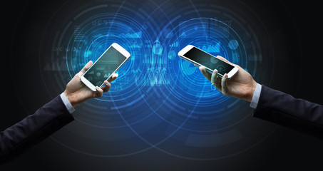 close up of two smartphones syncing business data