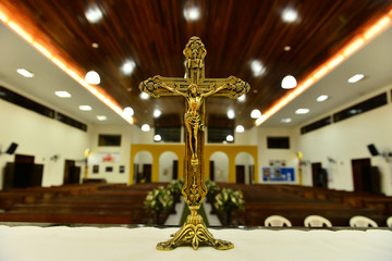 golden crucifix on the church altar, empty church, golden cross, metal cross, cross on the altar, catholic church altar,  Good Friday, Hallelujah Saturday, Easter Sunday, religious background