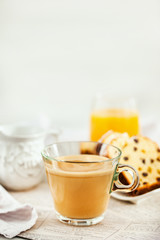 Wall Mural - Continental breakfast table with cup of hot  coffee with milk, cakes and orange juice