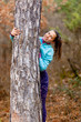 © Nikola Spasenoski - girl in a forest hiding behind tree