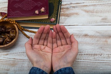 Koran - holy book of Muslims with rosary , date and dried flowers. ramadan concept