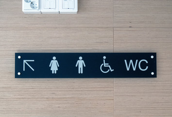 Toilet sign and direction on wall