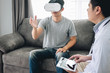 © Ngampol - Young asian man patient using virtual reality glasses to see technology