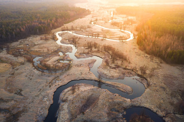 Wall Mural - Bright sunrise over wild curved river aerial view