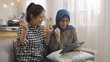 © PRPicturesProduction - Two multi ethnic friends excited found great deal in online store using digital pad. asian girls finish online payment on tablet credit card with yes hand sign gesture. korean and muslim women indoor