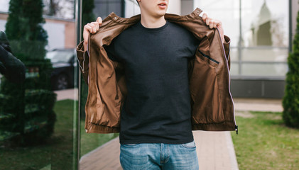 a stylish man in a black t-shirt. street photo