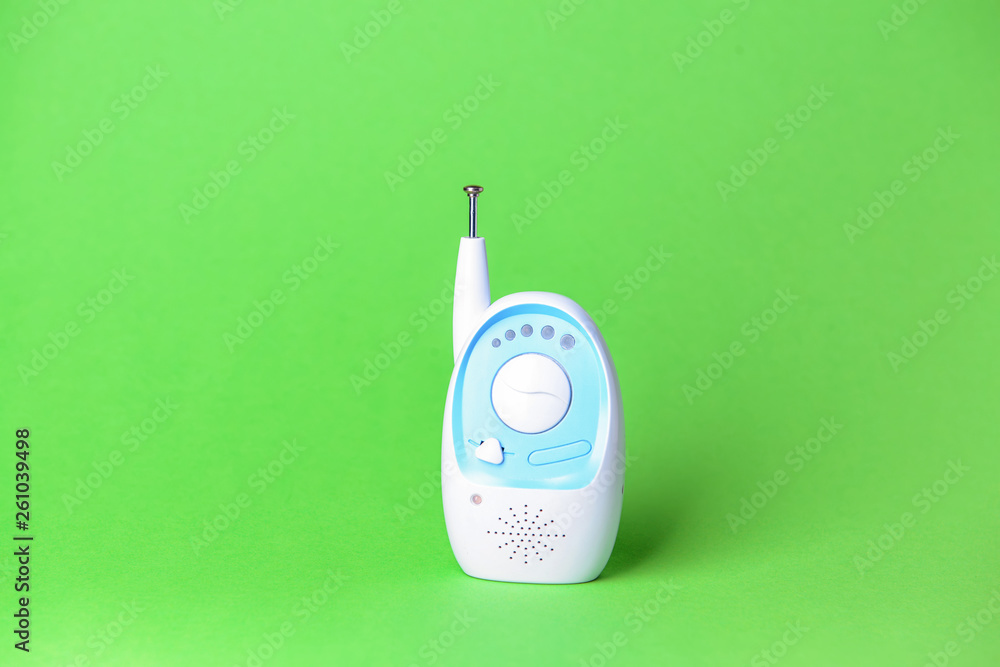 Modern baby monitor on color background