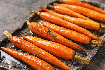 plate with tasty cooked carrot on table, closeup