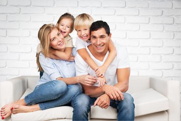 Beautiful smiling family in room on couch