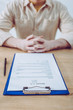 © LIGHTFIELD STUDIOS - selective focus of clipboard with resume cv lettering near recruiter with clenched hands