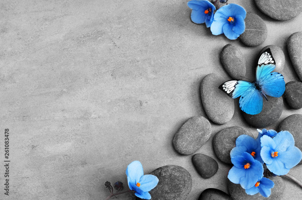 Blue flower and stone zen spa on grey background - obrazy, fototapety, plakaty 