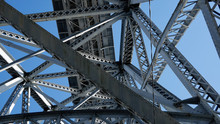 Metal Steel Girders On A Bridge From Below Against Blue Sky