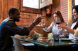 © guille Faingold/Stocksy - Friends toasting with glasses of wine in restaurant.