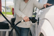 © Gillian Vann/Stocksy - man pumping gas