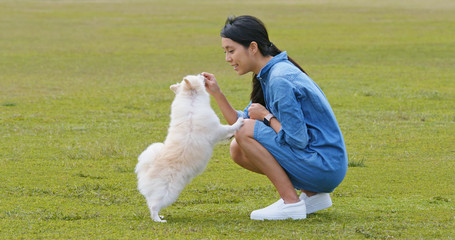 Poster - Woman play with her dog at outdoor park