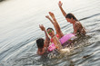 © BalanceFormCreative - Group of friends swimming and having fun in the lake.Female sitting on air mattress drinks lemonade and having fun with friends.