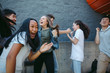 © Rob and Julia Campbell/Stocksy - Highschool friends dancing and celebrating together outside on t