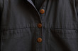 © Nicole Mason/Stocksy - buttons and pocket detail on jacket
