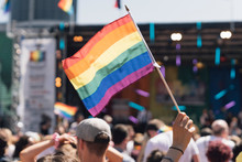 People With Rainbow Flags Attending A Gay Pride