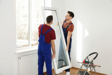 Sticker - Construction workers installing plastic window in house