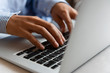 © Jamie Grill Photography/Tetra Images - Hands of woman typing on laptop
