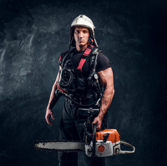 Wall Mural - Portrait of muscular man with chainsaw and respirator