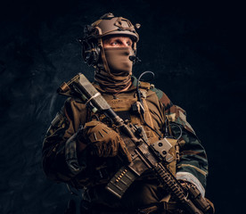 Wall Mural - Elite unit, special forces soldier in camouflage uniform posing with assault rifle.