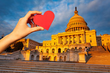 Hand Hold Red Heart Over Capitol In Washington, DC