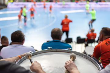 Wall Mural - Supporters drum during handball match.