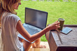 © astrosystem - Freelancer girl with smartphone, coffee / tea and laptop on a home porch.