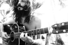 Portrait Of A Handsome Hippie Guy With A Guitar