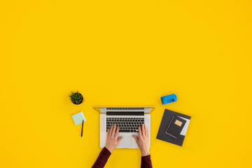 Man working on laptop top view. Copy space.