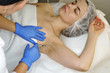 Hands of cosmetologist are close-ups injecting hyaluronic acid into armpit area of girl. Treatment of hyperhidrosis. Cosmetic procedure in spa salon.