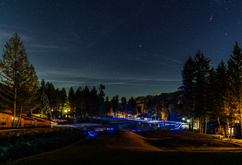 Wall Mural - Night landscape with stars on the sky at springtime.