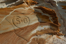 A Rock Outcrop With Interesting Patterns And Colors And A Heart Carved Into The Rock