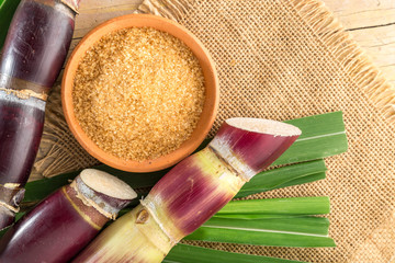 Brown sugar and cane on the table top view