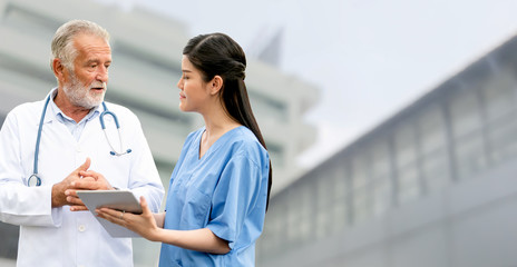 Wall Mural - Senior doctor working with young doctor in the hospital. Medical healthcare staff and doctor service.