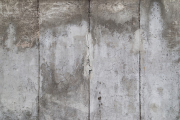 Close-up of a weathered and aged gray concrete wall. Full frame texture background of the original Berlin Wall.